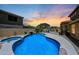 Sparkling blue pool with rock waterfall and tropical landscaping at 6712 W Miner Trl, Peoria, AZ 85383