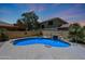 Inviting pool with rock waterfall feature and jacuzzi is surrounded by a well-kept wall for backyard privacy at 6712 W Miner Trl, Peoria, AZ 85383