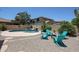 Backyard featuring a sparkling pool with a rock waterfall feature, spa, and lounge seating at 6712 W Miner Trl, Peoria, AZ 85383
