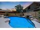Sparkling blue pool with rock waterfall and tropical landscaping at 6712 W Miner Trl, Peoria, AZ 85383