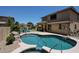 Beautiful backyard pool and spa with a waterfall feature and comfortable lounge seating area at 6712 W Miner Trl, Peoria, AZ 85383