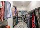 Well-organized walk-in closet with ample hanging space, shelving, and a stylish rug at 6712 W Miner Trl, Peoria, AZ 85383