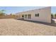 Expansive backyard with gravel surface and covered patio, offering versatility for outdoor activities at 6719 S Hardy Dr, Tempe, AZ 85283