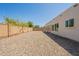 Low-maintenance gravel backyard providing a blank canvas for landscaping and recreation at 6719 S Hardy Dr, Tempe, AZ 85283