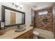 Bathroom features a vessel sink, granite countertop, a large mirror and a tiled shower over the bathtub at 6719 S Hardy Dr, Tempe, AZ 85283