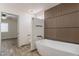 Stylish bathroom with modern soaking tub and wood accent wall at 6719 S Hardy Dr, Tempe, AZ 85283