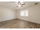 This is a bedroom with tile flooring, a ceiling fan, and a window for natural light at 6719 S Hardy Dr, Tempe, AZ 85283