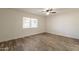 This bedroom has wood-look tile flooring, a ceiling fan, and a window for natural light at 6719 S Hardy Dr, Tempe, AZ 85283