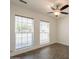 Bedroom features tile flooring, a ceiling fan, two windows, and white trim and baseboards at 6719 S Hardy Dr, Tempe, AZ 85283