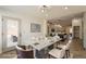 Bright dining room with modern table, chairs, and view into the kitchen and outside at 6719 S Hardy Dr, Tempe, AZ 85283