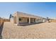 Exterior view of the home showcasing the spacious backyard with covered patio and gravel at 6719 S Hardy Dr, Tempe, AZ 85283