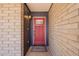 Welcoming red front door with glass detailing and a 'Welcome' mat, creating a warm and inviting entry at 6719 S Hardy Dr, Tempe, AZ 85283