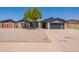 Charming single-story home with xeriscaped yard, complemented by mature tree and modern garage door at 6719 S Hardy Dr, Tempe, AZ 85283