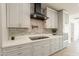 Modern kitchen has stone backsplash, cooktop, stainless appliances, and plenty of counter space at 6719 S Hardy Dr, Tempe, AZ 85283