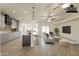 Open-concept living area with island kitchen, modern furnishings, and ample natural light at 6719 S Hardy Dr, Tempe, AZ 85283