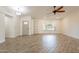 Bright and airy living room featuring tile floors, ceiling fan, built-in shelving, and ample natural light at 6719 S Hardy Dr, Tempe, AZ 85283