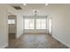 Sunlit living area features wood-look tile flooring, neutral walls, and backyard access at 6719 S Hardy Dr, Tempe, AZ 85283