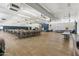 Large hall with tables and chairs, stage area, wood-look floors, recessed lighting and lots of natural light at 701 S Dobson Rd # 203, Mesa, AZ 85202
