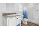 Bathroom featuring a vanity with white cabinets, a framed mirror, and a walk-in shower with curtain at 701 S Dobson Rd # 203, Mesa, AZ 85202