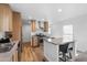 Bright kitchen boasts stainless steel appliances, a center island with bar seating, and modern finishes at 701 S Dobson Rd # 203, Mesa, AZ 85202