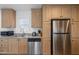 Modern kitchen featuring stainless steel appliances, ample counter space, and a window above the sink at 701 S Dobson Rd # 203, Mesa, AZ 85202