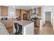 Kitchen featuring stainless steel appliances and breakfast bar with bar stools adjacent to living room at 701 S Dobson Rd # 203, Mesa, AZ 85202