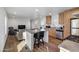 Kitchen open to living room featuring stainless steel appliances and a breakfast bar with bar stools at 701 S Dobson Rd # 203, Mesa, AZ 85202