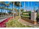 Inviting Tempe Marketplace entrance with lush landscaping and vibrant flower beds along a sunny road at 701 S Dobson Rd # 203, Mesa, AZ 85202