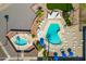 Aerial view of a pristine community pool featuring lounge chairs and shaded areas at 701 S Dobson Rd # 203, Mesa, AZ 85202