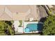 This aerial view showcases a private pool, patio with umbrellas, manicured lawn, and elegant home exterior at 7032 N 2Nd Ave, Phoenix, AZ 85021