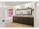A modern bathroom features a large mirror, double sinks, granite counters and tile floors at 7032 N 2Nd Ave, Phoenix, AZ 85021