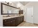 Bathroom featuring a large mirror, double sinks, granite counters and tile floors at 7032 N 2Nd Ave, Phoenix, AZ 85021