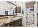 Neutral bathroom featuring granite counters, vanity, and shower with a cute animal themed shower curtain at 7032 N 2Nd Ave, Phoenix, AZ 85021
