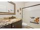 Neutral bathroom featuring granite counters, vanity, and a shower with a sliding glass door at 7032 N 2Nd Ave, Phoenix, AZ 85021