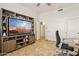 Bedroom featuring tile flooring and an entertainment center with a large television at 7032 N 2Nd Ave, Phoenix, AZ 85021