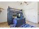 A bedroom featuring a bunk bed, sliding closet doors, tile floors and ceiling fan at 7032 N 2Nd Ave, Phoenix, AZ 85021