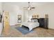 A cozy bedroom featuring tiled floors, a ceiling fan, a comfortable bed, and a chest of drawers at 7032 N 2Nd Ave, Phoenix, AZ 85021