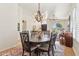 Elegant dining room featuring hardwood floors, decorative chandelier, and views to living room at 7032 N 2Nd Ave, Phoenix, AZ 85021