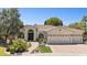 Attractive single-story home showcasing a three-car garage, tile roof, landscaped yard, and welcoming front entry at 7032 N 2Nd Ave, Phoenix, AZ 85021