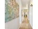 Hallway with beautiful hardwood floors, art, neutral walls, and recessed lighting at 7032 N 2Nd Ave, Phoenix, AZ 85021