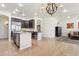 Open-concept kitchen with stainless steel appliances, island, and view of the living area at 7032 N 2Nd Ave, Phoenix, AZ 85021