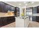 Stylish kitchen featuring dark wood cabinets, granite counters, and stainless steel refrigerator at 7032 N 2Nd Ave, Phoenix, AZ 85021