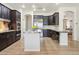 Spacious kitchen with stainless appliances, large island, dark cabinets, and ample counter space at 7032 N 2Nd Ave, Phoenix, AZ 85021
