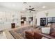 Spacious living room with a view of the kitchen, leather seating, and natural light at 7032 N 2Nd Ave, Phoenix, AZ 85021