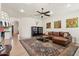 Comfortable living room featuring leather sectional sofa, area rug, and neutral wall color at 7032 N 2Nd Ave, Phoenix, AZ 85021