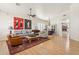 Open concept living room features hardwood floors, a ceiling fan and flows into the dining room at 7032 N 2Nd Ave, Phoenix, AZ 85021