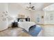 Serene primary bedroom featuring a ceiling fan, tiled floors, and natural light at 7032 N 2Nd Ave, Phoenix, AZ 85021
