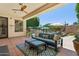 Inviting covered patio featuring comfortable seating, ceiling fan, and view of the sparkling pool at 7032 N 2Nd Ave, Phoenix, AZ 85021