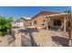 Landscaped backyard with a paved patio, lush greenery, and covered patio at 716 E Horizon Heights Dr, San Tan Valley, AZ 85143