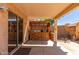 Covered patio with outdoor kitchen area provides a relaxing space for entertaining at 716 E Horizon Heights Dr, San Tan Valley, AZ 85143